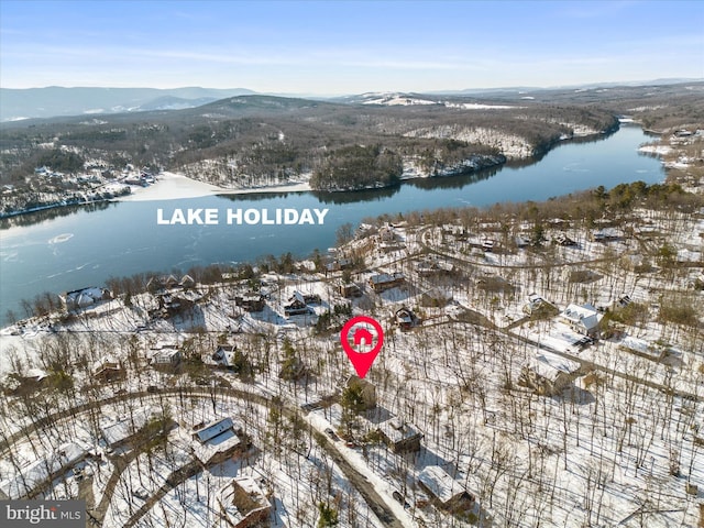 snowy aerial view with a water and mountain view