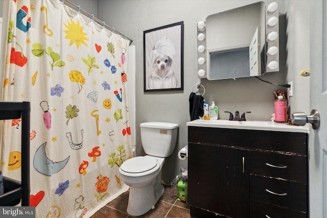 bathroom featuring toilet, vanity, tile patterned flooring, and curtained shower