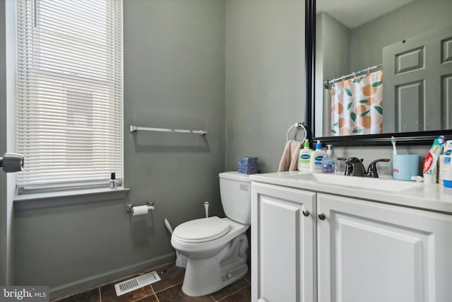 bathroom featuring tile patterned floors, toilet, and vanity