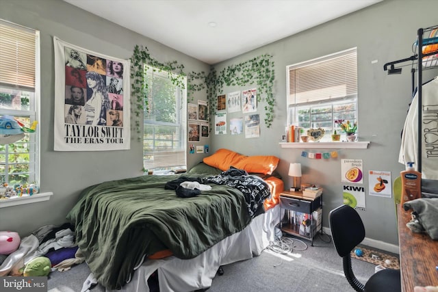 carpeted bedroom featuring multiple windows