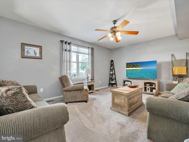 carpeted living room with ceiling fan