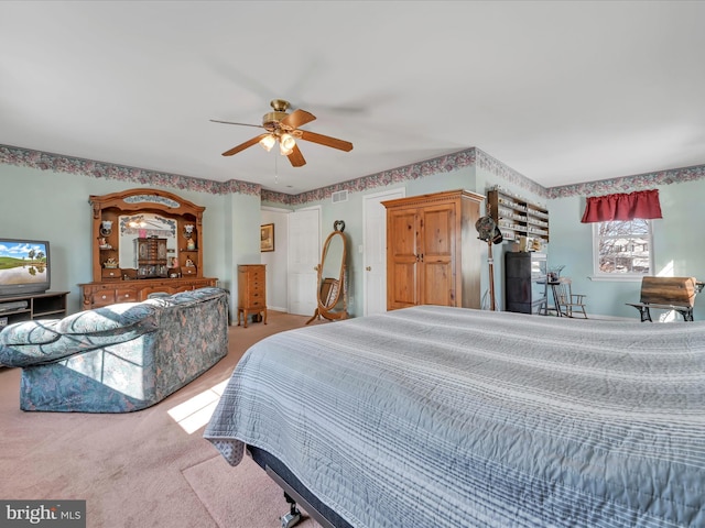 bedroom featuring light colored carpet and ceiling fan