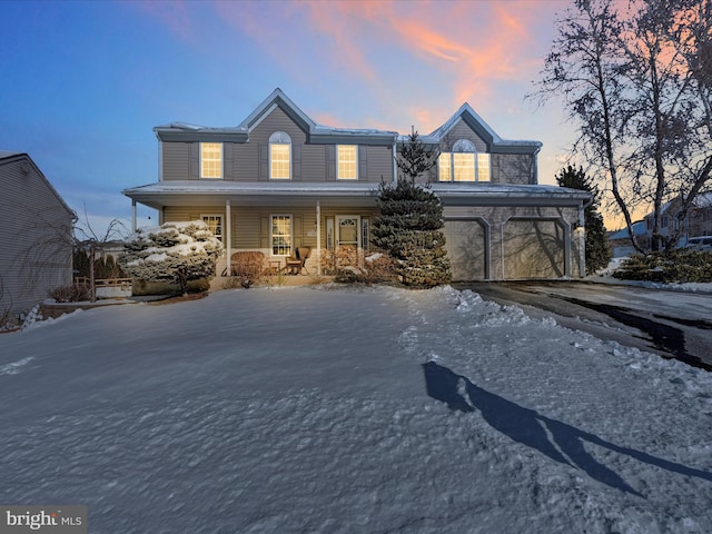 view of front property featuring a garage and covered porch