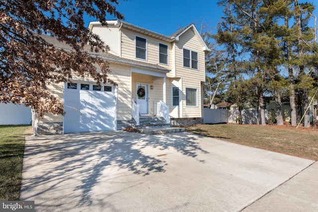 front of property featuring a front lawn and a garage