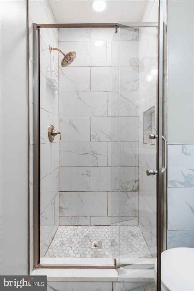 bathroom with a shower with door