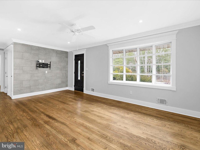 unfurnished room featuring crown molding, hardwood / wood-style floors, and ceiling fan