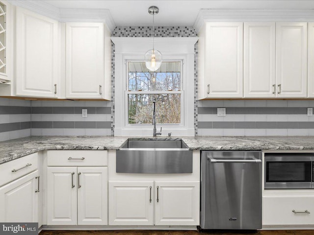 kitchen featuring white cabinetry, appliances with stainless steel finishes, sink, and light stone counters