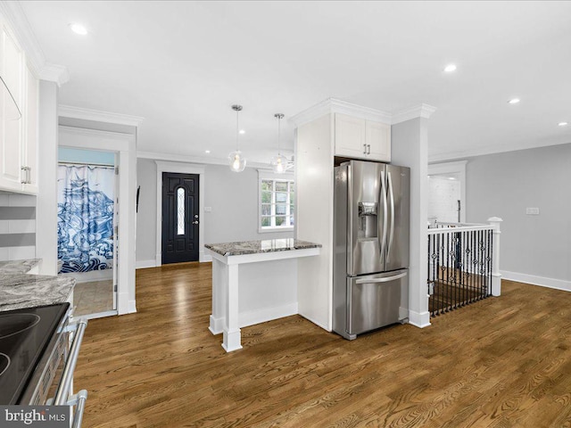 kitchen featuring white cabinetry, hanging light fixtures, stainless steel appliances, and light stone countertops