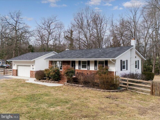 ranch-style home with a garage and a front yard