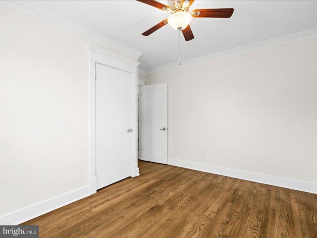 unfurnished room featuring crown molding, hardwood / wood-style floors, and ceiling fan