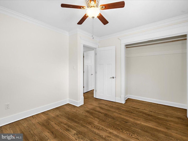 unfurnished bedroom with dark hardwood / wood-style flooring, crown molding, a closet, and ceiling fan