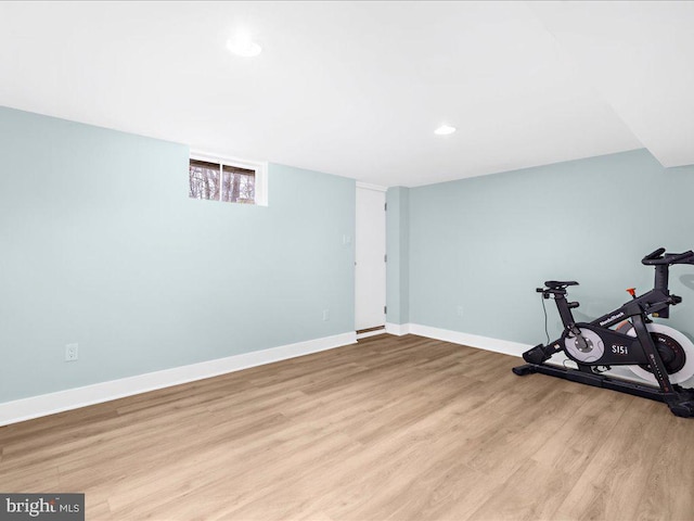 exercise room with light wood-type flooring