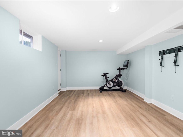 workout room with light hardwood / wood-style floors