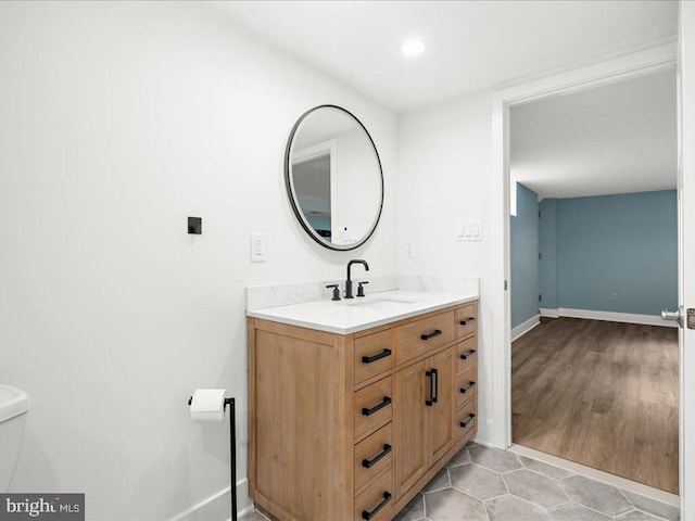 bathroom featuring vanity, tile patterned floors, and toilet