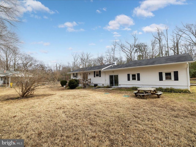 rear view of property with a yard