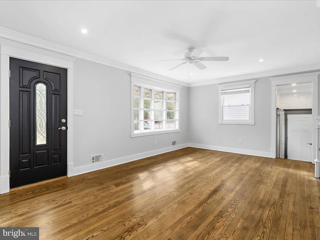 foyer entrance with crown molding, ceiling fan, and wood-type flooring