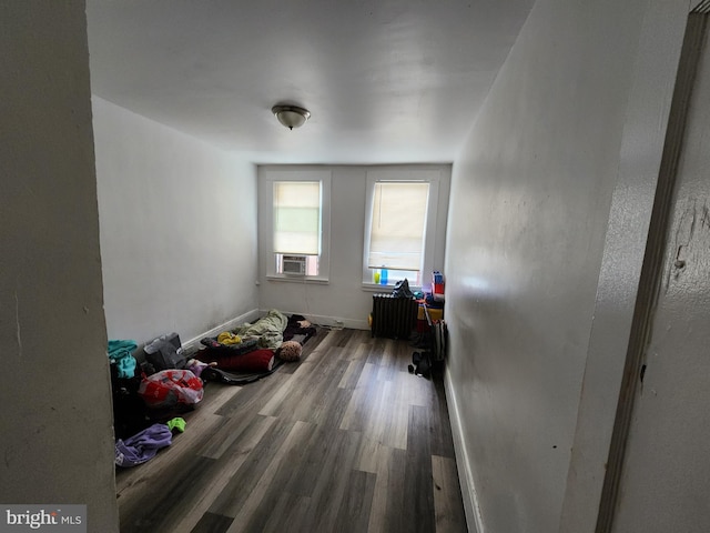 bedroom featuring hardwood / wood-style flooring and cooling unit