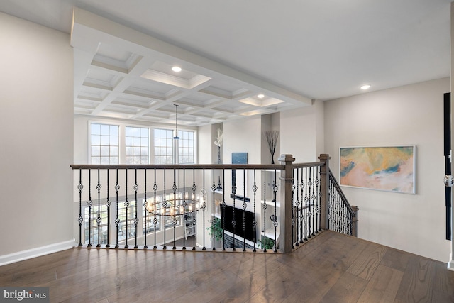 hall with wood-type flooring, beam ceiling, and coffered ceiling