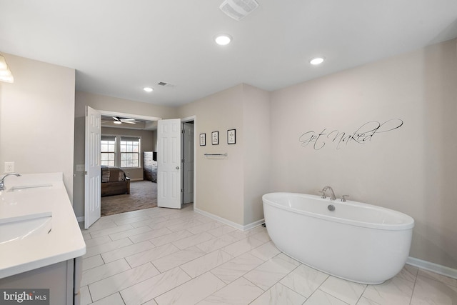 bathroom featuring vanity and a tub