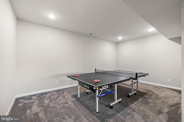 rec room with dark colored carpet