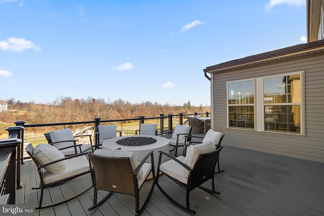 deck featuring an outdoor fire pit