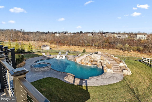 view of swimming pool with a shed, a lawn, pool water feature, and a hot tub