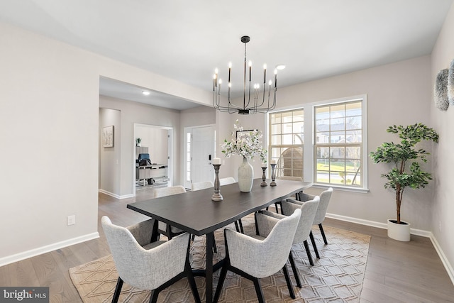 dining space featuring an inviting chandelier and dark wood-type flooring