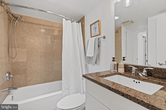 full bathroom featuring vanity, shower / tub combo, and toilet