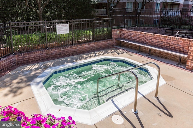 view of pool with a hot tub