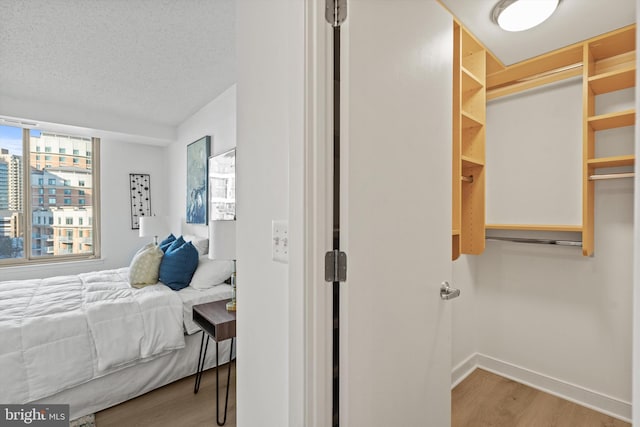 bedroom featuring hardwood / wood-style flooring and a textured ceiling