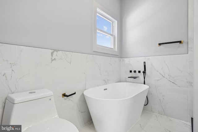 bathroom with a tub, tile walls, and toilet