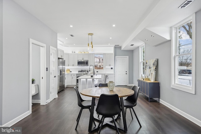 dining room with dark wood-type flooring and sink