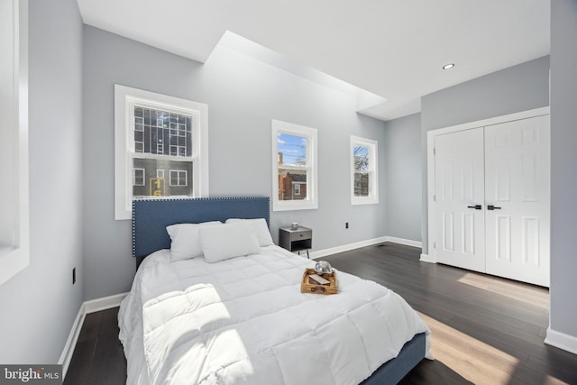 bedroom with a closet and dark hardwood / wood-style floors