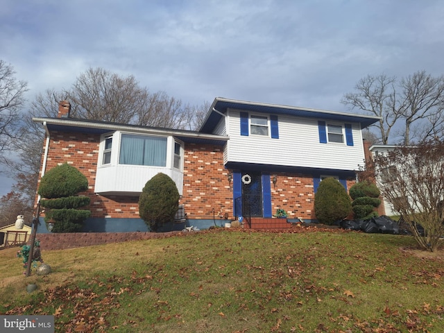 tri-level home with a front yard