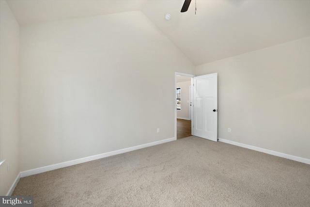 spare room with ceiling fan, high vaulted ceiling, and carpet flooring