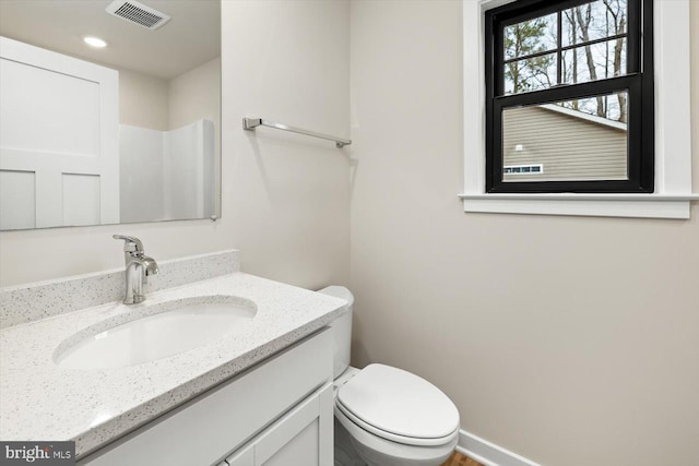 bathroom featuring toilet and vanity