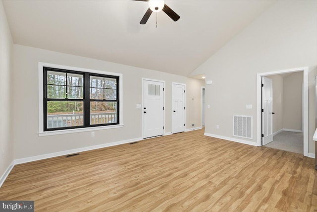 unfurnished living room with light wood-type flooring, ceiling fan, and high vaulted ceiling