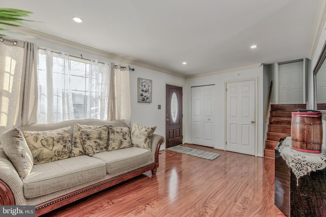 living room featuring hardwood / wood-style floors and crown molding