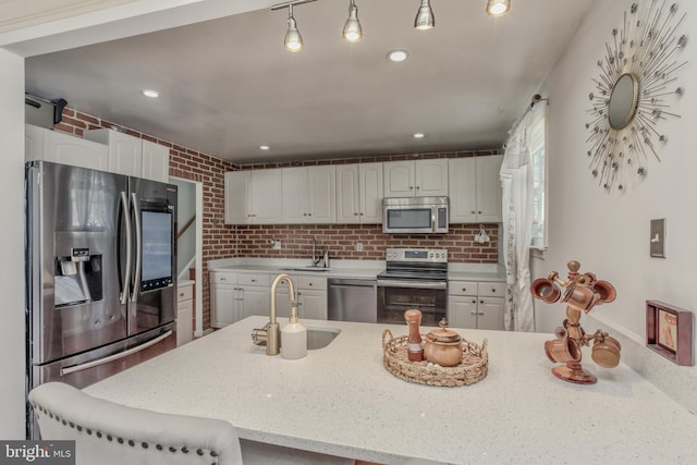 kitchen featuring white cabinets, backsplash, and appliances with stainless steel finishes