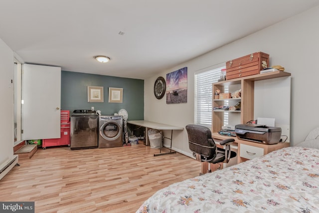 bedroom featuring washing machine and dryer, light hardwood / wood-style floors, and a baseboard radiator