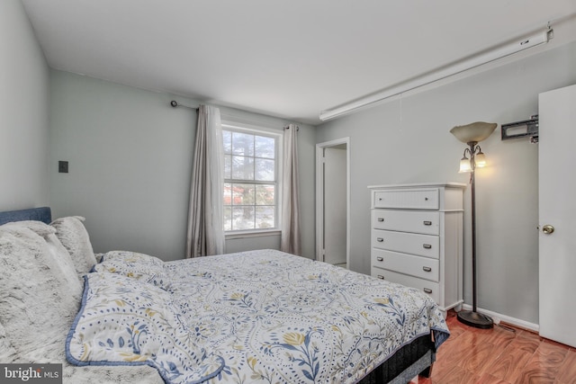 bedroom with hardwood / wood-style floors