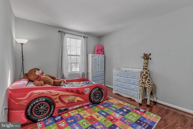 bedroom with dark hardwood / wood-style flooring