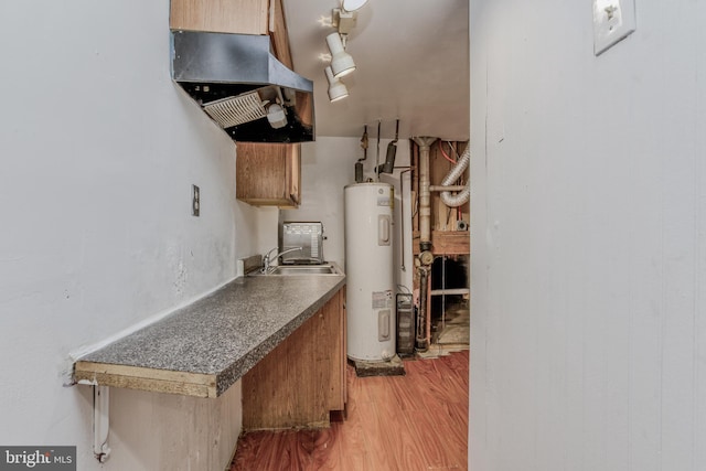 kitchen featuring electric water heater, island range hood, sink, and hardwood / wood-style floors