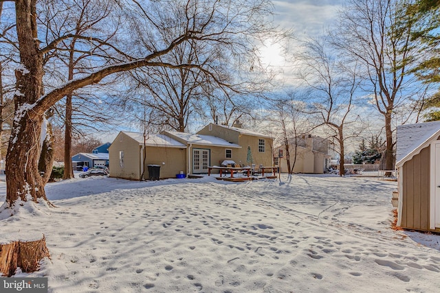 view of snow covered rear of property