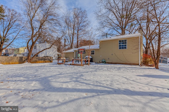 snow covered property featuring a wooden deck