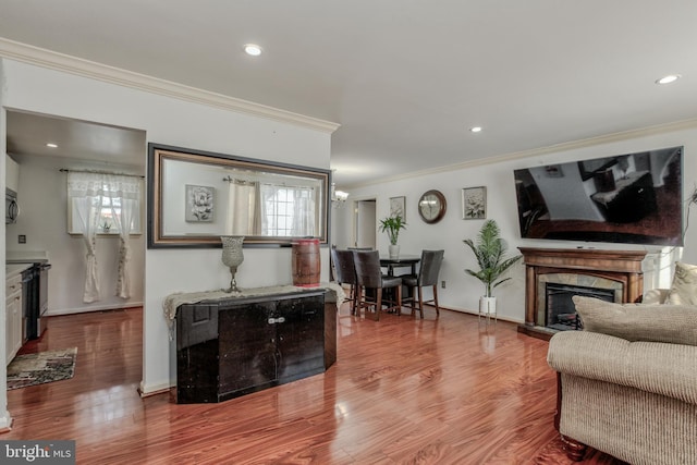 living room with wood-type flooring and ornamental molding