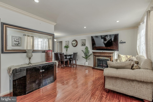 living room featuring hardwood / wood-style flooring and ornamental molding