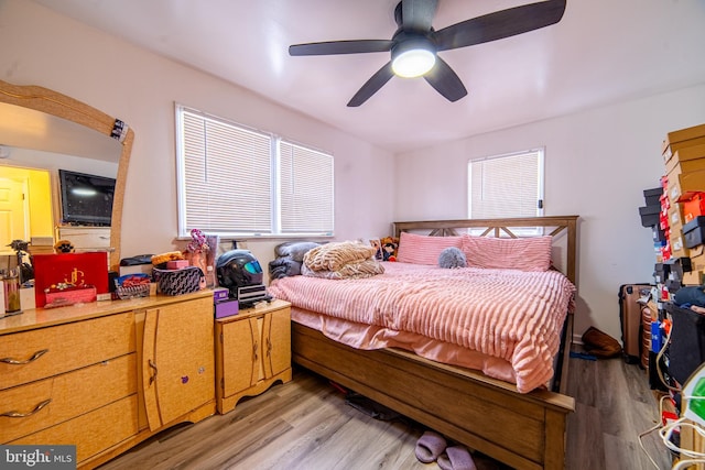 bedroom with light hardwood / wood-style flooring and ceiling fan