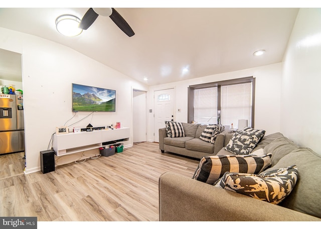 living room with light wood-type flooring, ceiling fan, and lofted ceiling