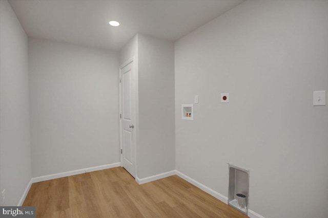 clothes washing area with light hardwood / wood-style floors, hookup for a washing machine, and electric dryer hookup